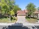 Charming home exterior featuring mature trees, a well-maintained lawn, and a covered entryway at 2836 Linkview Dr, Las Vegas, NV 89134