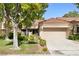Charming single-story home featuring a two-car garage, tile roof, and mature trees enhancing the front yard at 2836 Linkview Dr, Las Vegas, NV 89134