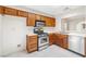 Efficient kitchen with stainless steel appliances, wooden cabinets, and tile flooring for easy maintenance at 2836 Linkview Dr, Las Vegas, NV 89134