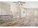 Spacious living room with wood-look floors, neutral paint, and modern ceiling fan at 2836 Linkview Dr, Las Vegas, NV 89134
