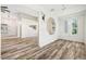 Open-concept living room with modern lighting and wood-look flooring at 2836 Linkview Dr, Las Vegas, NV 89134