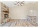 Bright living room featuring a stone fireplace, wood flooring, and neutral tones for a comfortable atmosphere at 2836 Linkview Dr, Las Vegas, NV 89134