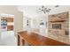 Open-concept living room with stone fireplace, hardwood floors, and easy access to the kitchen area at 2836 Linkview Dr, Las Vegas, NV 89134