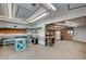Spacious basement workshop with ample lighting, work benches, and storage shelves, ideal for DIY projects at 3143 El Chico Ct, Las Vegas, NV 89120