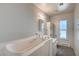 Bright bathroom with walk-in tub and storage at 3143 El Chico Ct, Las Vegas, NV 89120