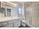 The bathroom features a vanity, toilet, shower and window at 3143 El Chico Ct, Las Vegas, NV 89120