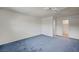 Primary bedroom with blue carpet and ensuite bathroom at 3143 El Chico Ct, Las Vegas, NV 89120