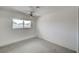 A bedroom with a window, ceiling fan, white walls and carpet at 3143 El Chico Ct, Las Vegas, NV 89120