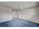 A spacious bedroom with blue carpet, white walls and a ceiling fan at 3143 El Chico Ct, Las Vegas, NV 89120