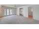 Sunlit living room features built-in shelving and glass doors to backyard and pool at 3143 El Chico Ct, Las Vegas, NV 89120