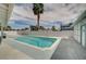 Backyard swimming pool surrounded by a white brick wall and a tall palm tree, offering a private oasis at 3143 El Chico Ct, Las Vegas, NV 89120