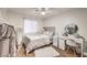 Cozy bedroom with plush carpeting, a ceiling fan, and ample natural light at 3440 Meridale Dr, Las Vegas, NV 89117