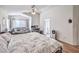 Spacious bedroom with a large bed, sofa, and a ceiling fan, offering comfort and style at 3440 Meridale Dr, Las Vegas, NV 89117
