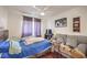 Cozy bedroom featuring a comfortable bed, a sofa, and a window with blackout curtains at 3440 Meridale Dr, Las Vegas, NV 89117
