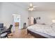 Comfortable bedroom with a bed, ceiling fan, and a glimpse into the en-suite bathroom at 3440 Meridale Dr, Las Vegas, NV 89117