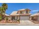 Two-story home with tile roof, palm trees, well-maintained landscaping, and a two-car garage at 3440 Meridale Dr, Las Vegas, NV 89117