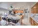Bright kitchen with oak cabinets, tile countertops and breakfast bar seating for three at 3440 Meridale Dr, Las Vegas, NV 89117