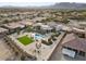 Expansive backyard with pool, turf lawn, seating area, and desert landscaping on a modern home at 4050 N Tomsik St, Las Vegas, NV 89129