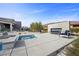 Backyard showcasing a spa, outdoor seating, fireplace and stylish landscaping at 4050 N Tomsik St, Las Vegas, NV 89129
