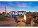Expansive backyard with a pool, lounge chairs and fire pit for evening relaxation at 4050 N Tomsik St, Las Vegas, NV 89129