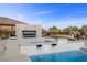Backyard featuring an outdoor fireplace, spa, and elegant seating at 4050 N Tomsik St, Las Vegas, NV 89129