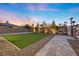 Backyard with turf, stone and gravel, and landscaped border in a modern backyard at 4050 N Tomsik St, Las Vegas, NV 89129