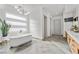 Modern bathroom with freestanding tub, sleek fixtures, and bright natural light from horizontal windows at 4050 N Tomsik St, Las Vegas, NV 89129