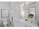 Well-lit bathroom with a spacious vanity, toilet, modern fixtures, and a decorative flower market print for added charm at 4050 N Tomsik St, Las Vegas, NV 89129