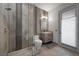 Elegant bathroom featuring glass shower, tiled walls, modern vanity, and natural lighting at 4050 N Tomsik St, Las Vegas, NV 89129