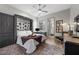 Cozy bedroom with custom built-ins, a ceiling fan, and views to an ensuite bathroom and outside at 4050 N Tomsik St, Las Vegas, NV 89129