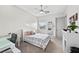 Bright bedroom featuring a ceiling fan, a cozy bed and a dedicated desk space, perfect for study and rest at 4050 N Tomsik St, Las Vegas, NV 89129