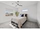 Bright bedroom with a ceiling fan, a cozy bed, and scenic outdoor views for a comfortable and peaceful retreat at 4050 N Tomsik St, Las Vegas, NV 89129