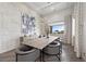 Bright dining room features a large table, unique light fixture, modern art and textured accent wall at 4050 N Tomsik St, Las Vegas, NV 89129