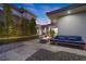 Contemporary outdoor sitting area with firepit, blue couch, trees, gravel and pavers at 4050 N Tomsik St, Las Vegas, NV 89129