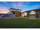 Exterior home at sunset with turf, gravel and stone, and an outdoor firepit area at 4050 N Tomsik St, Las Vegas, NV 89129