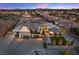 A well lit, modern home boasts a three-car garage and manicured landscaping in a planned community at 4050 N Tomsik St, Las Vegas, NV 89129