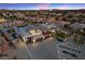 An aerial view of a modern, well-lit home with a three-car garage in a planned community at 4050 N Tomsik St, Las Vegas, NV 89129
