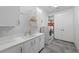 Bright laundry room with front loading washer, dryer and ample cabinet storage at 4050 N Tomsik St, Las Vegas, NV 89129