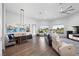 Open-concept living room with hardwood floors, modern furnishings, recessed lighting, and large windows at 4050 N Tomsik St, Las Vegas, NV 89129