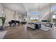 Open living room featuring hardwood floors, high ceilings, modern decor, and a piano at 4050 N Tomsik St, Las Vegas, NV 89129