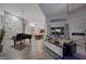 Open-concept living room with piano, modern fireplace, and view of the backyard at 4050 N Tomsik St, Las Vegas, NV 89129