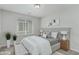 Neutral bedroom features a Queen bed, window with blinds, and bedside tables with lamps at 4512 Moon Hill Rock Ave, North Las Vegas, NV 89084