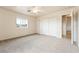 This bedroom features plush carpeting, a closet, a window, and ceiling fan at 480 China St, Pahrump, NV 89048