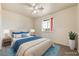 Staged bedroom with neutral carpet, a ceiling fan, window, and coordinated bedding for a cozy feel at 480 China St, Pahrump, NV 89048