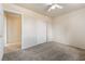 Cozy bedroom featuring neutral carpet flooring and a closet, leading to another room at 480 China St, Pahrump, NV 89048