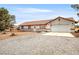 Charming single-story home with a tile roof, gravel yard, and attached two-car garage at 480 China St, Pahrump, NV 89048