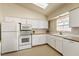 Well-lit kitchen features white cabinets, modern appliances, and a window over the sink at 480 China St, Pahrump, NV 89048