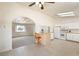 Open kitchen boasts white appliances, a breakfast bar, and seamless flow into living area at 480 China St, Pahrump, NV 89048