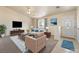 Staged living room boasts plush seating, a sleek TV, and a stylish rug enhancing its inviting atmosphere at 480 China St, Pahrump, NV 89048