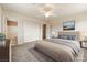 This main bedroom boasts neutral colors, a ceiling fan, and an attached bathroom at 480 China St, Pahrump, NV 89048
